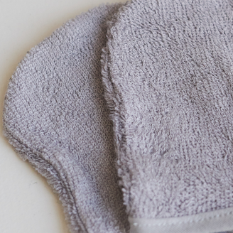 Light grey face cleansing mitts made from 100% organic bamboo fiber, highlighting a soft, plush, and ultra-fine woven texture safe for sensitive skin.
