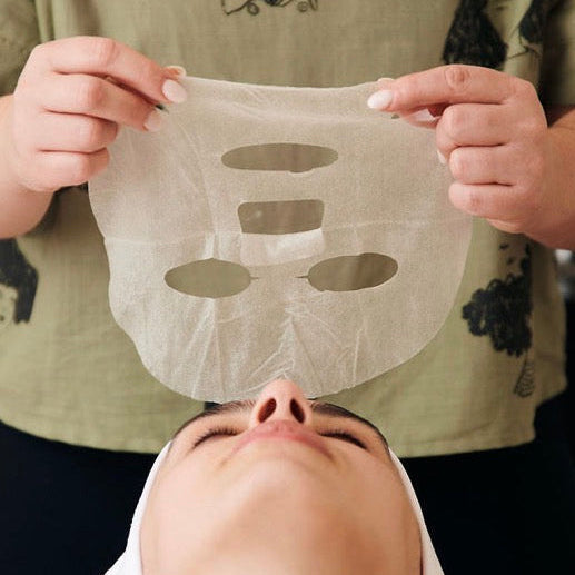 Professional application of the Corthe Calming Complexion Mask; a clinical-grade Korean sheet mask used post-procedure to instantly soothe redness with Madecassoside and 6-weight Hyaluronic Acid.