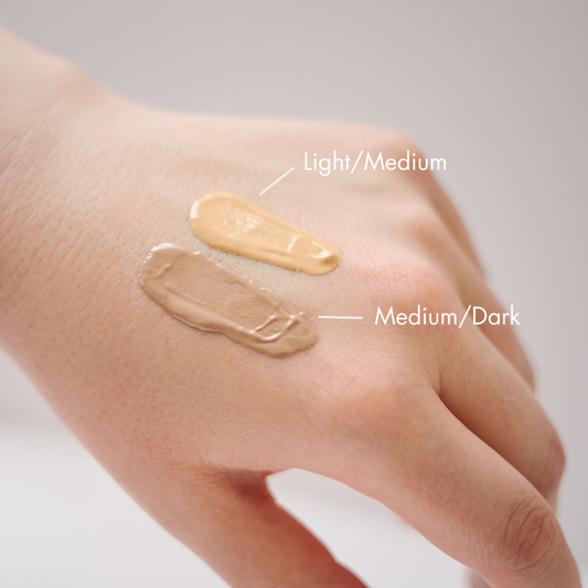 Close-up of KrX Korean Tinted Sunscreen in Light/Medium and Medium/Dark; a skin-perfecting solution that solves "orange peel texture" by providing breathable mineral coverage that blurs imperfections while treating the skin with antioxidants.