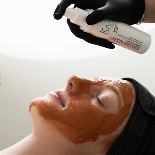 Watch the transformation: Spraying the activation mist onto the KrX Mud Mask to transition the detox mud into a hydrating, peel-off sheet mask.
