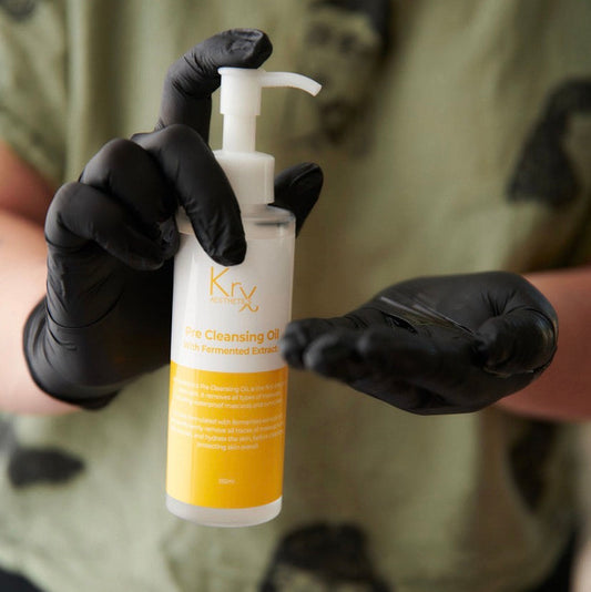 Professional application of KrX Pre Cleansing Oil to dry skin to gently melt away impurities as the first step of a double cleanse routine.