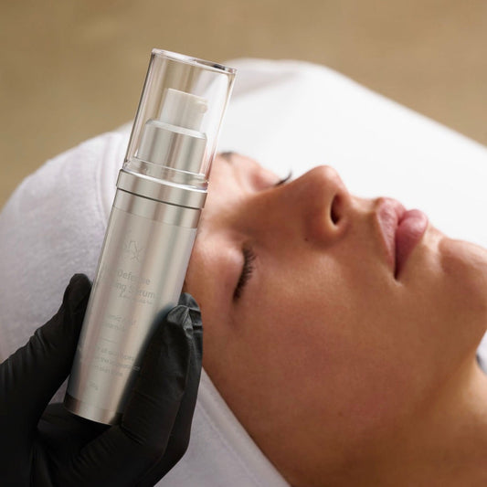 Applying KrX Mela Défense Serum to fade stubborn dark spots and sun damage.