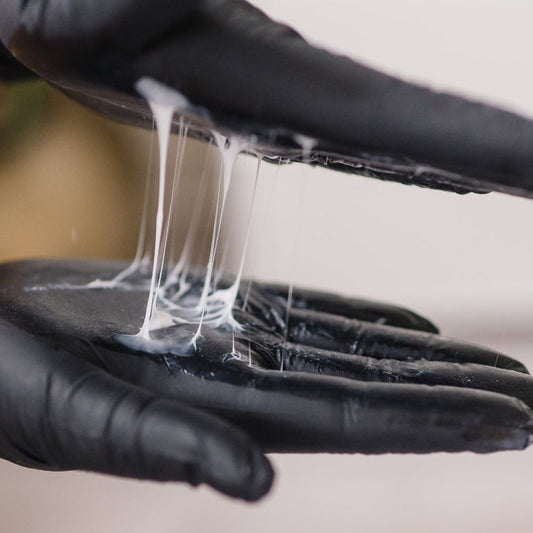 The signature elastic, stringy texture of KrX The Neck Lift, which physically mirrors the skin's collagen network to visibly tighten and lift lax skin on contact.