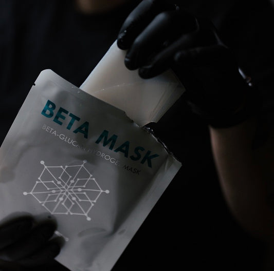 Professional handling of the Neogenesis Beta Glucan Hydrogel Mask in a clinical setting, emphasizing its sterile, pharmaceutical-grade formulation for safe use on compromised skin.