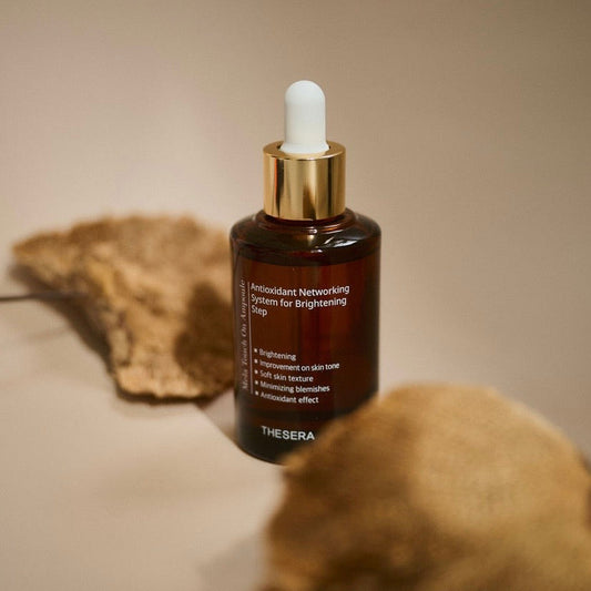 Thesera brightening serum with 10% PHA and Vitamin C, shown on a textured stone surface to highlight its professional, medical-grade Korean formulation.