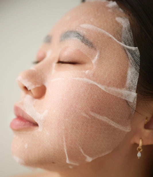 High-adhesion K-Beauty Skincare biocellulose sheet mask application showing the second-skin fit for 100% serum absorption and instant facial contour lifting.