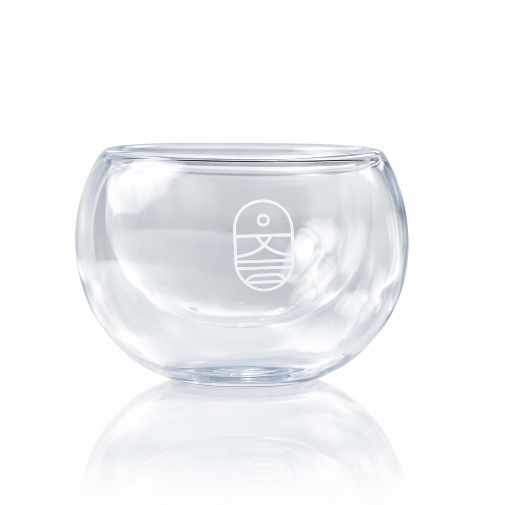 Double-walled glass mask mixing bowl for professional and at-home skincare rituals, designed to minimize product waste and maintain formula temperature.