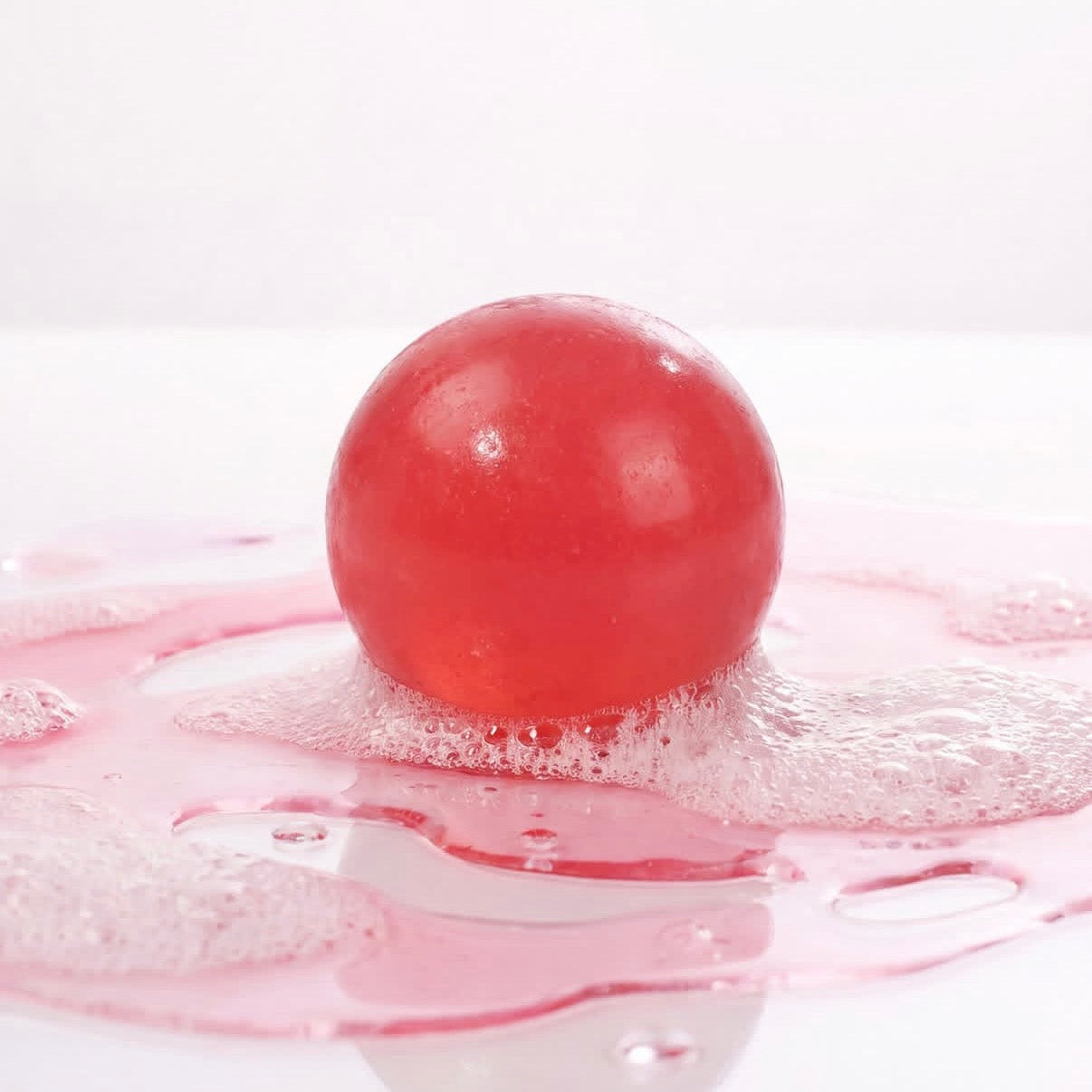 Beauty Body Factorie PDRN Bouncy Ball Soap lathering with pink foam for skin barrier repair and cellular body care