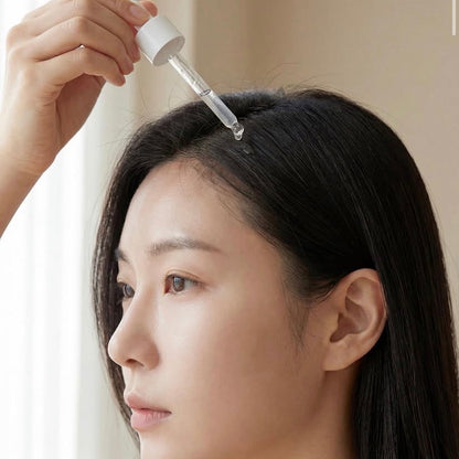 BHF Scalp Booster Korean Hair Serum being applied directly to clean hair using a dropper to stimulate microcirculation and treat a dry scalp.