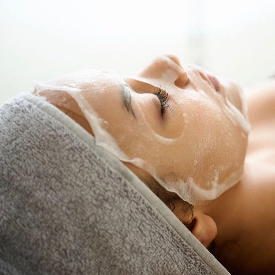 Side view of the Corthe clinical sheet mask showing perfect contouring to the face, ensuring the Berry Antioxidant Complex and Amino Acids penetrate deeply to repair the skin barrier.