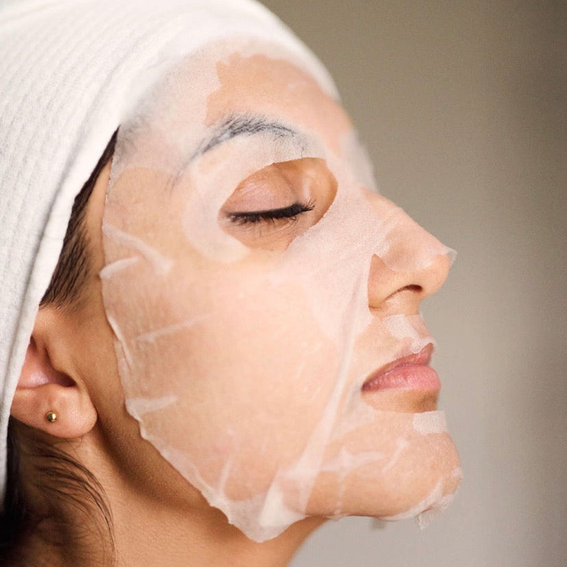 A model wearing the Corthe Calming Complexion Mask; a professional-grade Korean treatment that uses gentle AHAs to dissolve surface dullness and clear pores on sensitive, reactive skin.