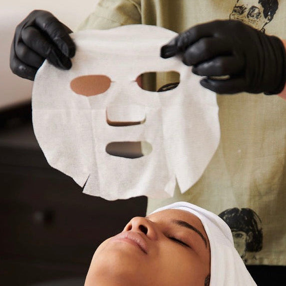 A cooling Dermathod Triple Action Korean face and neck mask being applied to soothe redness and replenish moisture with mineral-rich Glacial Water.