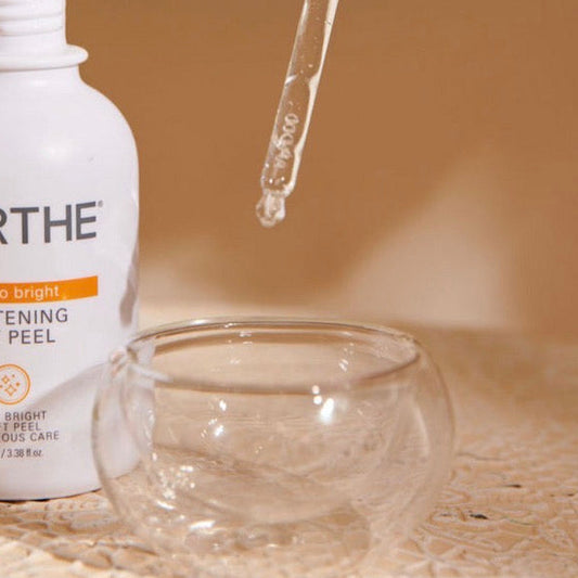 Dispensing a skincare serum into the glass masking bowl to minimize product waste and ensure a hygienic facial treatment.