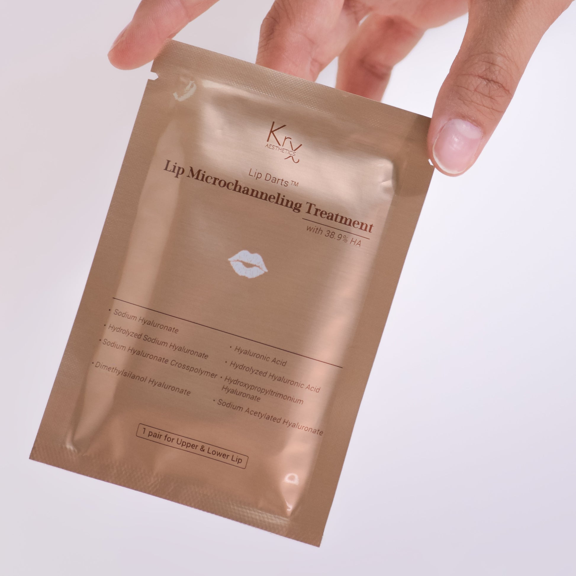 Elegant gold packaging of the KrX Lip Darts+, a sophisticated Korean plumping ritual that delivers 8 molecular weights of hyaluronic acid deep into the lip tissue.