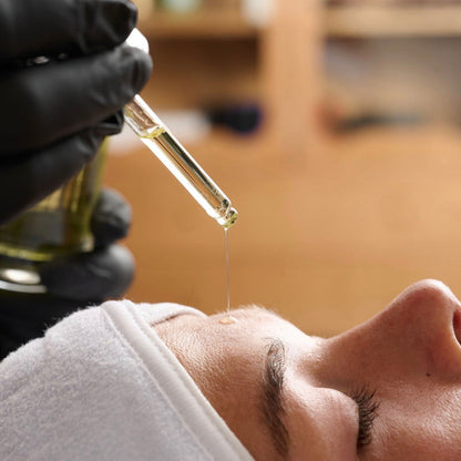 Applying Thesera Mela Touch On Korean Brightening Ampoule to skin for clinical dark spot and hyperpigmentation correction.