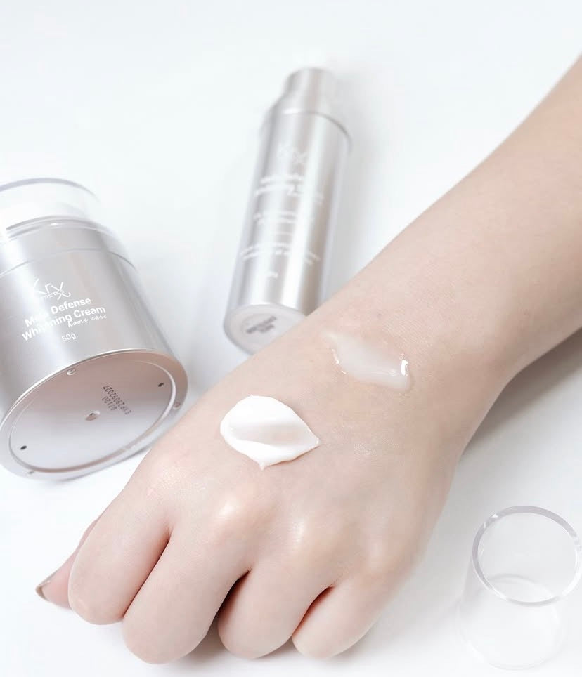 The lightweight, silky texture of KrX Mela Défense Serum absorbing into the skin, formulated with RiFerm-NPG fermented rice water for a non-greasy, brightening finish.