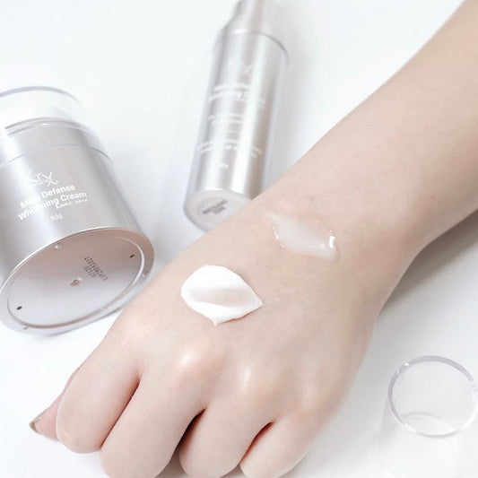 Texture of KrX Mela Defense Cream being applied to the skin to treat hyperpigmentation and uneven tone with clinical-grade Niacinamide and NPG.