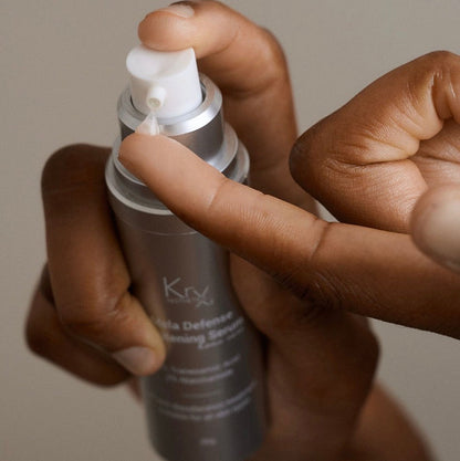 Dispensing the KrX Mela Défense Brightening Serum, a professional clinical treatment that targets dark spots and sun damage while supporting the skin barrier.