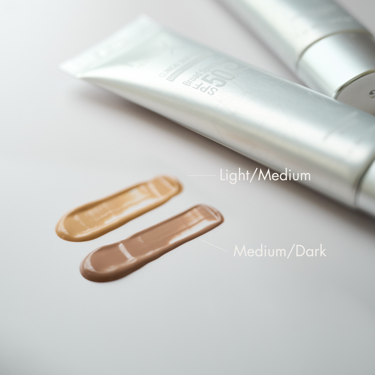 A sheer swatch of KrX Clinical Skin Filter SPF 50; a blurring solution that solves "texture-emphasis" by using a soft-focus tint and Niacinamide to visually "erase" pores for a smooth, filtered skin appearance.