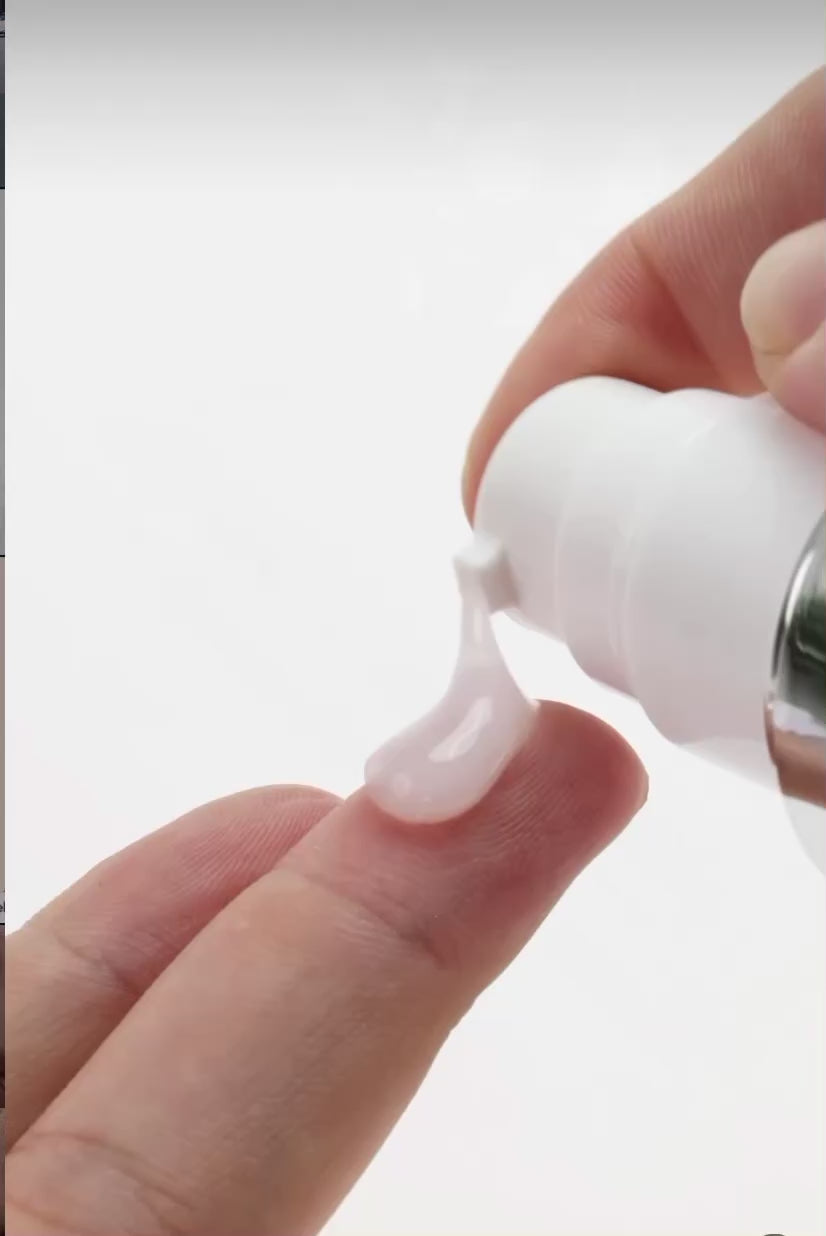 Applying KrX Face Lift Serum to clean skin to target fine lines and visible skin laxity.