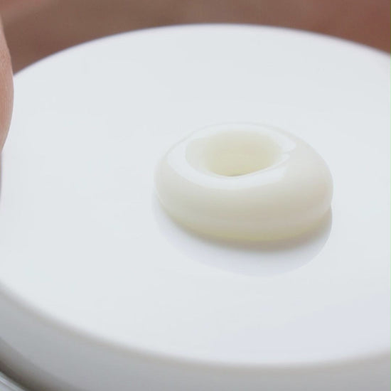 Application of KrX Mela Defense Cream featuring Tranexamic Acid and Niacinamide for even skin tone.