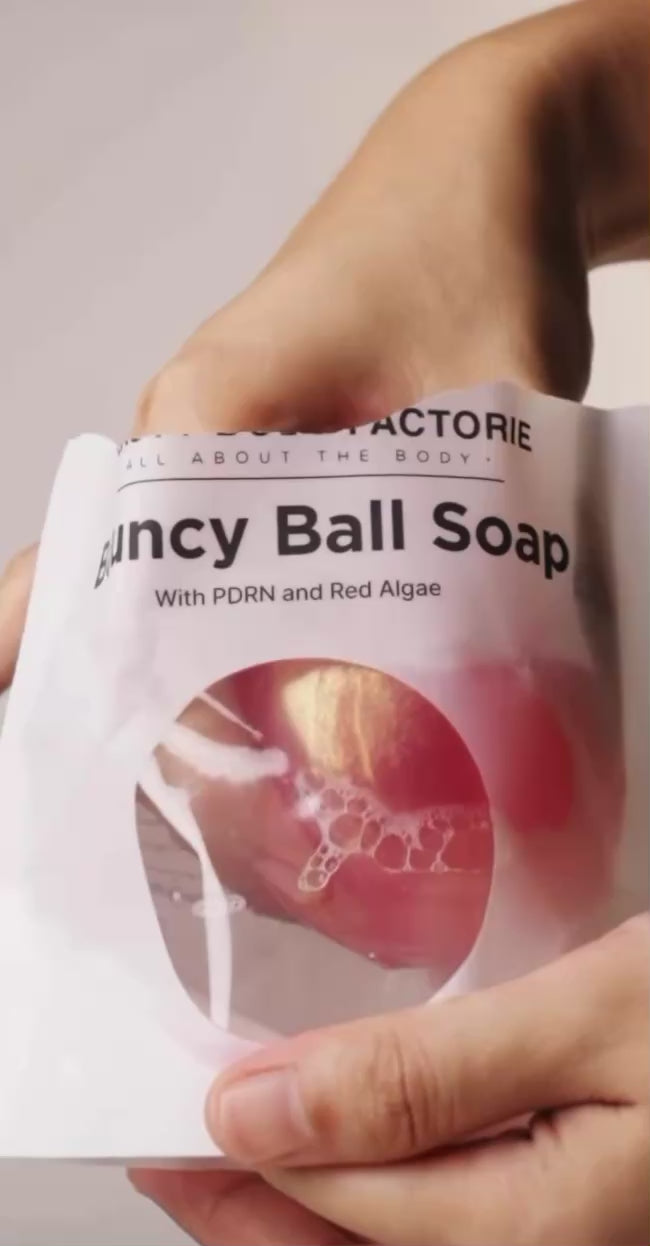 Korean PDRN bouncy ball soap for cellular body repair and deep hydration, featuring Sodium DNA and Red Algae for a firm, youthful glow.