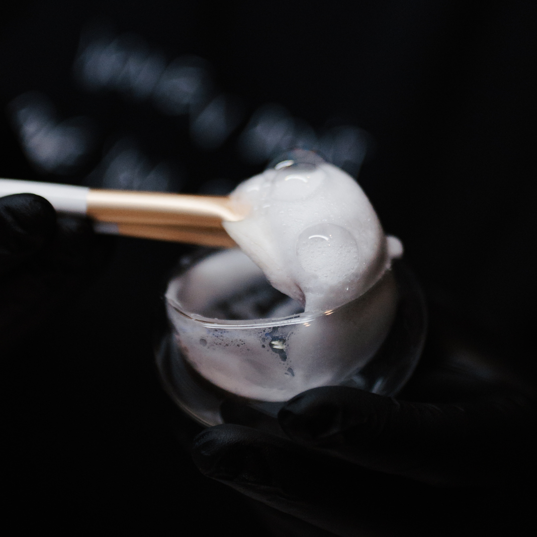 Showing the rich, cushiony foam of Corthe's Enzyme Cleanser activated with water to deep-clean pores and refine skin texture using botanical Papain enzymes