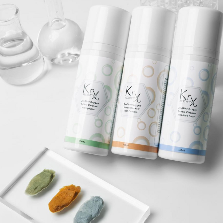 The complete KrX OxyGlow Bundle; an environmental-defense solution that solves "travel-stressed skin" by providing the exact remedy needed—whether it's detoxing urban pollutants with Spirulina or soothing water-sensitivity with Blue Tansy.