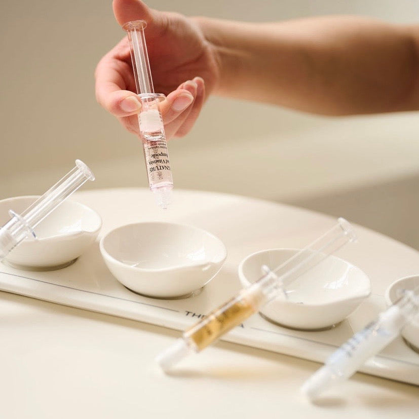 Applying the Thesera clinical /Korean  ampoule using a precision dropper to target specific skin concerns like fine lines, congestion, and dullness.