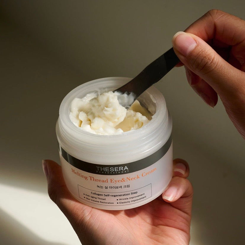 A close-up of the rich, fibrous texture of Thesera L-FTING Melting Thread Cream being scooped with a spatula, showcasing the professional-grade anti-glycation formula for needle-free skin lifting.