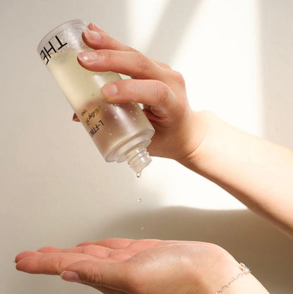 Close-up of the liquid-soluble Thesera L-FTING Toner being poured, showing the lightweight texture that delivers nano-chitosan threads deep into the skin to begin the lifting process.