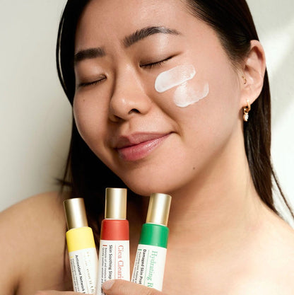 Applying Thesera Mela Touch On Korean Brightening Cream to cheeks to neutralize blue light damage and restore a radiant, even skin tone.