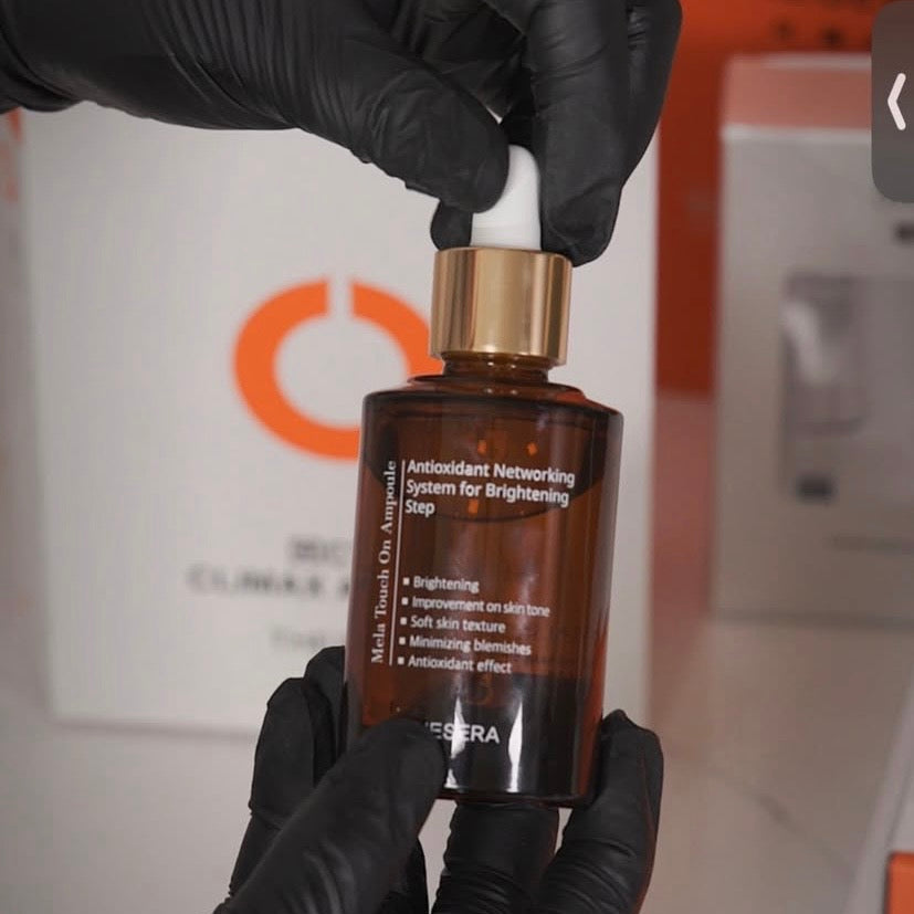 Professional application of the Thesera Mela Touch On K-Beauty skincare Ampoule, showing the 6-vitamin antioxidant blend designed to heal and glow.